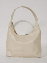 Sac à main beige en cuir vegan, forme épurée et douce